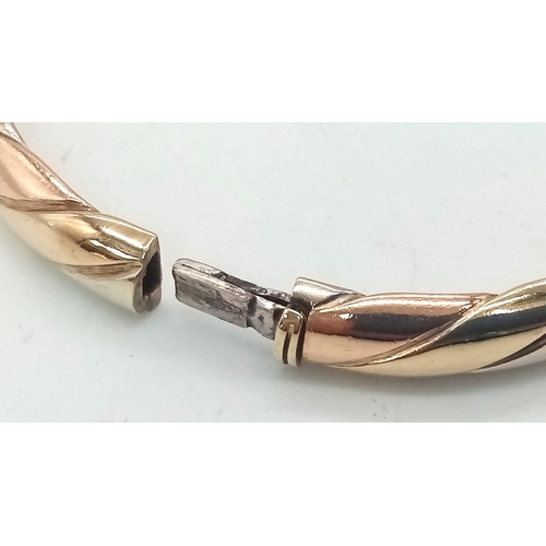 2 - A Vintage 9K Tri-Colour Gold Bangle. Yellow, rose and white gold diagonal strip decoration. Clip ope... 