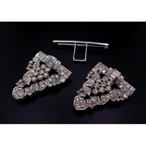 108 - An Art Deco Style 18K White Gold and Diamond Double Clip Brooch. 2ct approx. of round brilliant and ... 