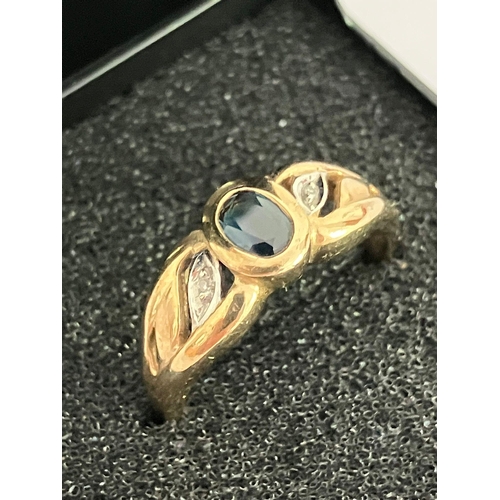 189 - 9 carat Yellow and White GOLD RING with SAPPHIRE to centre and having DIAMONDS set to pierced GOLD S... 