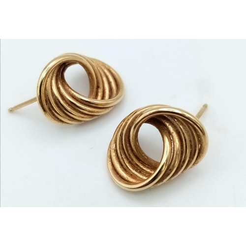 304 - A Pair of 9K Yellow Gold Circle Twist Earrings. 2.4g total weight. No butterflies.