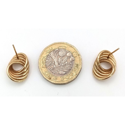 304 - A Pair of 9K Yellow Gold Circle Twist Earrings. 2.4g total weight. No butterflies.