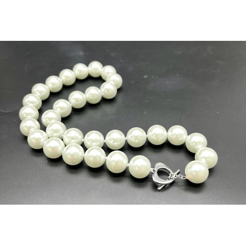 429 - A Bright White South Sea Pearl Shell Large Bead Necklace. Heart clasp. 14mm beads.