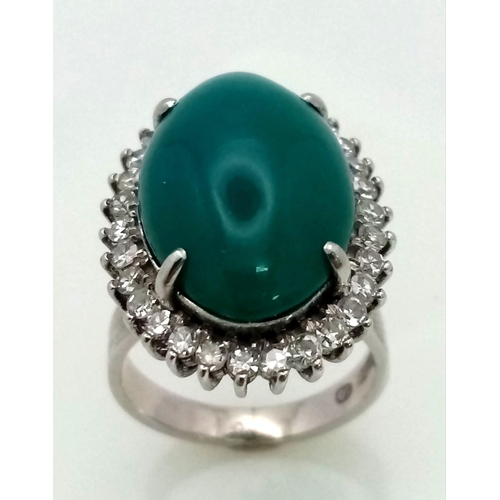 79 - A 18K WHITE GOLD GREEN JADE CENTRE STONE SURROUNDED BY DIAMONDS RING . 0.66CT  CABOCHON DIAMOND TOTA... 