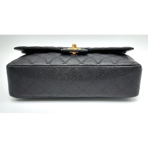 31 - A VINTAGE BLACK CAVIAR LEATHER CHANEL FLAP BAG. 24K GOLD PLATED HARDWARE. LOVELY INTERIOR POCKETS CO... 