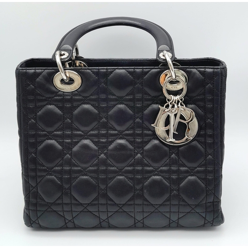 59 - The Season's Lady Dior bag by Christian Dior is crafted from black quilted Lambskin leather. The int... 