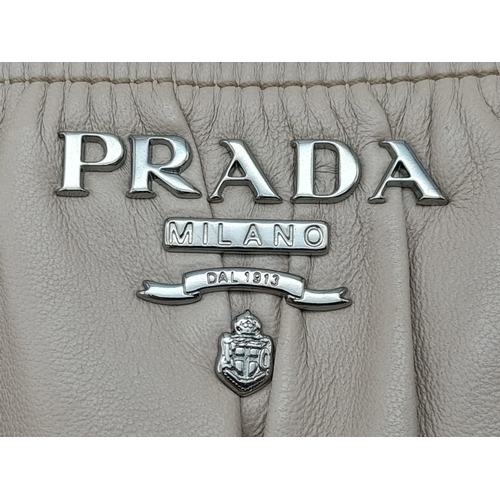 169 - A PRADA BEIGE NAPPA LEATHER GAUFRE POMICE TOTE BAG. SILVER TONE HARD WEAR INCLUDING BUCKLE DETAIL. T... 