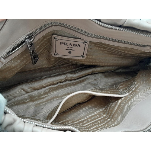 169 - A PRADA BEIGE NAPPA LEATHER GAUFRE POMICE TOTE BAG. SILVER TONE HARD WEAR INCLUDING BUCKLE DETAIL. T... 