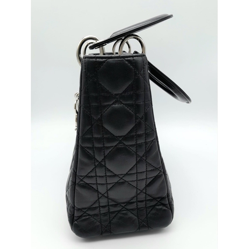 59 - The Season's Lady Dior bag by Christian Dior is crafted from black quilted Lambskin leather. The int... 