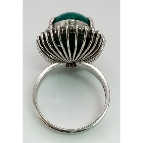 79 - A 18K WHITE GOLD GREEN JADE CENTRE STONE SURROUNDED BY DIAMONDS RING . 0.66CT  CABOCHON DIAMOND TOTA... 