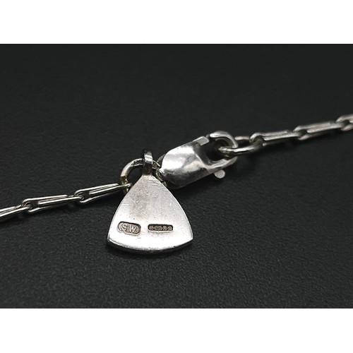 115 - An 18K White Gold Rutilated Quartz and Diamond Pendant on an 18K White Gold Link Necklace. A mesmeri... 