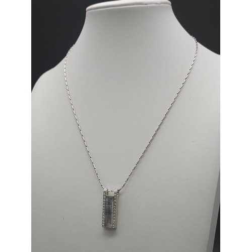 115 - An 18K White Gold Rutilated Quartz and Diamond Pendant on an 18K White Gold Link Necklace. A mesmeri... 