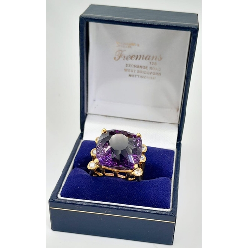 140 - A very glamorous, sterling silver and gold ring with a large, cushion cut, quality amethyst (17 x 17... 