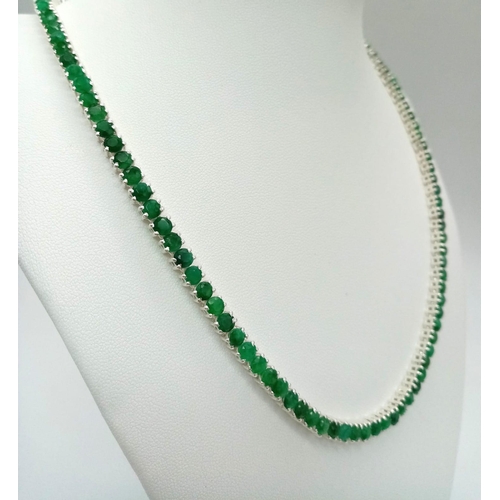 76 - A Beautiful Emerald Tennis Necklace. Set in 925 silver. 44cm