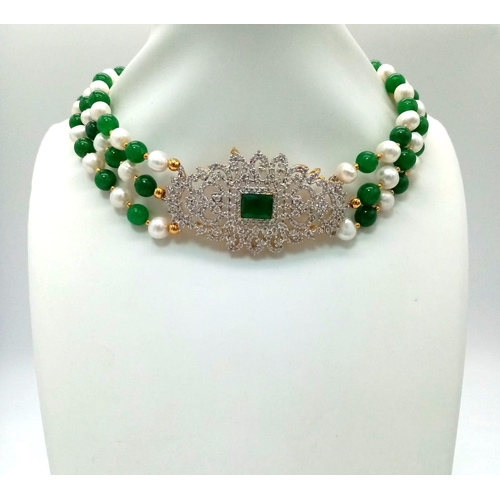 97 - A Green Jade and Cultured Pearl Three Row Choker Necklace.  Artistic jade and white stone centre-pie... 