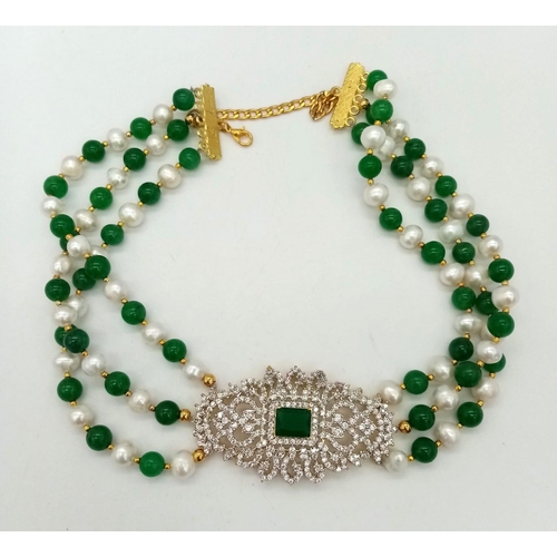 97 - A Green Jade and Cultured Pearl Three Row Choker Necklace.  Artistic jade and white stone centre-pie... 