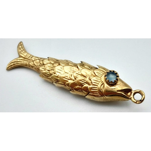 45 - A Vintage 9k Yellow Gold Articulated Fish Pendant/Charm with Aquamarine Eyes. 4cm. 3.11g weight.