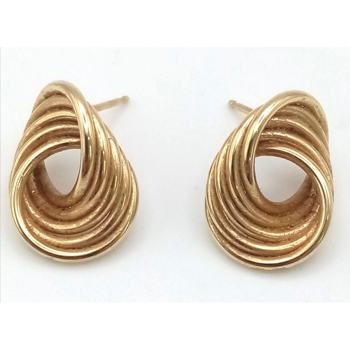 1691 - A Pair of 9K Yellow Gold Circle Twist Earrings. 2.4g total weight. No butterflies.