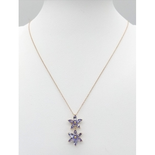 169 - An Unworn 9 Carat Yellow Gold & Tanzanite Set Double Flower Design Pendant Necklace. 46cm Length... 