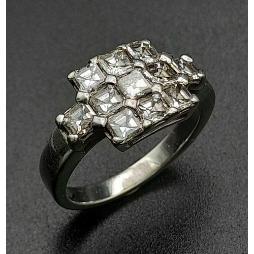 107 - A 950 Platinum and Diamond Ring. Eleven princess cut diamonds. 2.2ctw approx. Size O. 7.23g total we... 