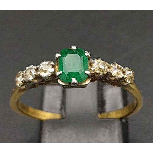 177 - A Vintage 18K Yellow Gold Diamond and Emerald Ring. Central emerald with three old cut diamonds on e... 