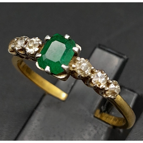 177 - A Vintage 18K Yellow Gold Diamond and Emerald Ring. Central emerald with three old cut diamonds on e... 