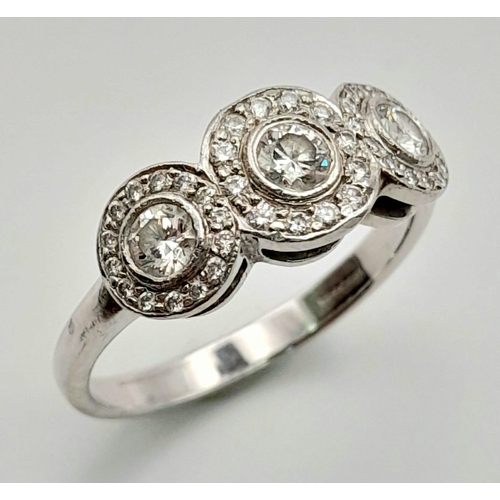 284 - A Tiffany and Co. 18K White Gold and Diamond Ring. A trilogy of round cut diamonds each with its own... 