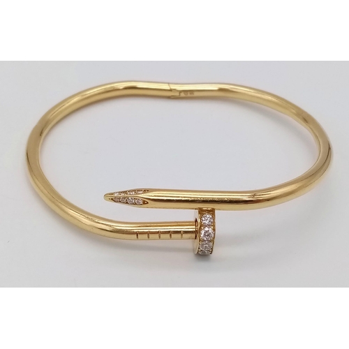 5 - A 18K YELLOW GOLD 0.45CT DIAMOND SET CARTIER STYLE NAIL BANGLE. TOTAL WEIGHT 34.34G. THE WIDEST INNE... 