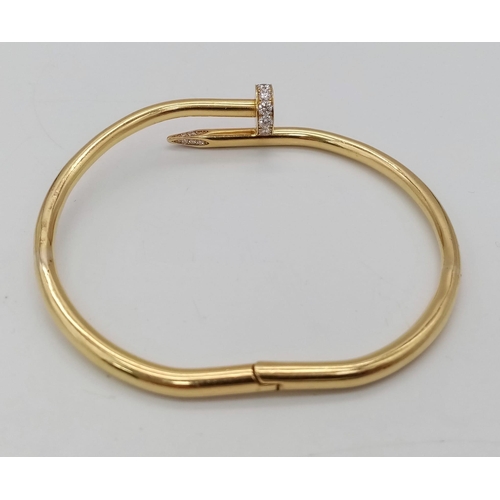 5 - A 18K YELLOW GOLD 0.45CT DIAMOND SET CARTIER STYLE NAIL BANGLE. TOTAL WEIGHT 34.34G. THE WIDEST INNE... 