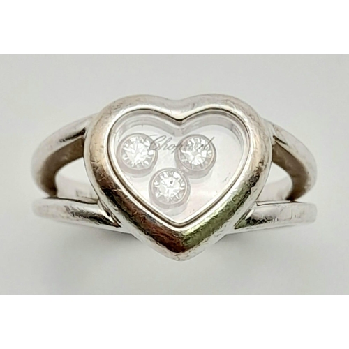 57 - An 18K White Gold Chopard Happy Diamond Ring. Heart shaped with three floating diamonds - 0.17ct. Co... 