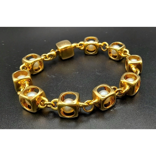 71 - A Designer (Gio Caroli) 18K Yellow Gold and Pearl Bracelet. Nine beautiful South Sea pearls - each e... 