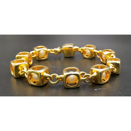 71 - A Designer (Gio Caroli) 18K Yellow Gold and Pearl Bracelet. Nine beautiful South Sea pearls - each e... 