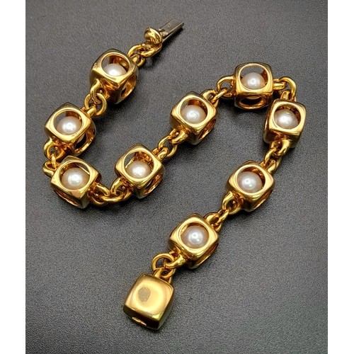 71 - A Designer (Gio Caroli) 18K Yellow Gold and Pearl Bracelet. Nine beautiful South Sea pearls - each e... 