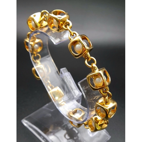 71 - A Designer (Gio Caroli) 18K Yellow Gold and Pearl Bracelet. Nine beautiful South Sea pearls - each e... 