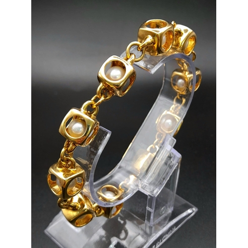 71 - A Designer (Gio Caroli) 18K Yellow Gold and Pearl Bracelet. Nine beautiful South Sea pearls - each e... 