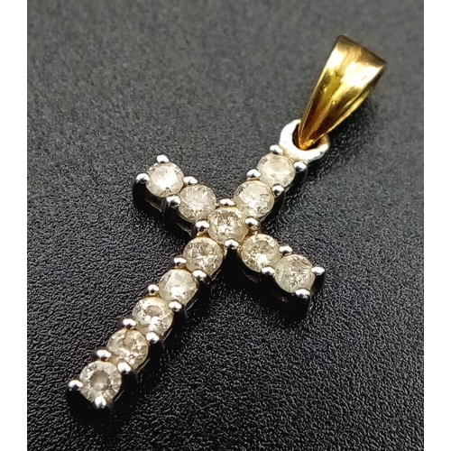 211 - A Gold and Platinum Diamond Cross Pendant. 12 round cut diamonds - each representing a disciple. 1.5... 