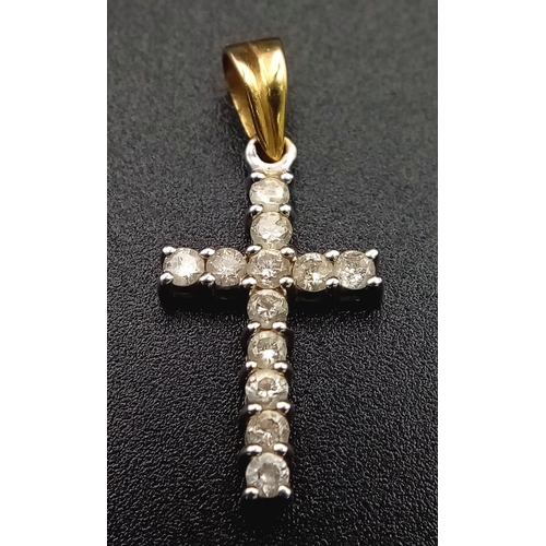 211 - A Gold and Platinum Diamond Cross Pendant. 12 round cut diamonds - each representing a disciple. 1.5... 