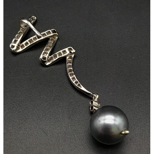 225 - A Platinum, Diamond and Grey Tahitian Pearl Spiral Pendant.
6cm. 5.12g total weight. Ref: 13890