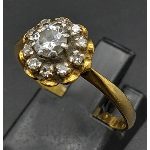 270 - A Vintage 18K Yellow Gold Diamond Ring. Central round cut diamond surrounded by a halo of diamonds. ... 