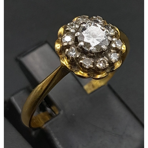 270 - A Vintage 18K Yellow Gold Diamond Ring. Central round cut diamond surrounded by a halo of diamonds. ... 