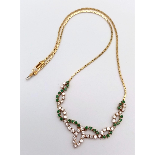 135 - An 18K Yellow Gold Diamond and Green Stone Necklace. 40cm length with a diamond drop. 36 round cut d... 