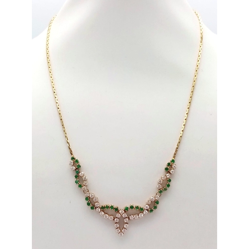 135 - An 18K Yellow Gold Diamond and Green Stone Necklace. 40cm length with a diamond drop. 36 round cut d... 