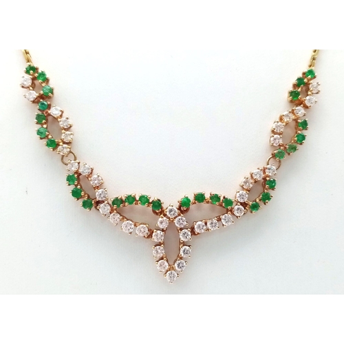 135 - An 18K Yellow Gold Diamond and Green Stone Necklace. 40cm length with a diamond drop. 36 round cut d... 