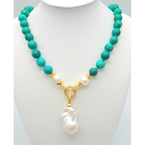 291 - An Exquisite Blue Turquoise and Baroque Pearl Necklace. 10mm turquoise beads lead to a Baroque Drop!... 