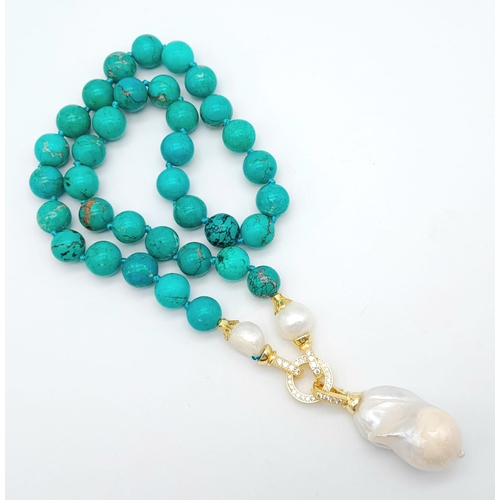 291 - An Exquisite Blue Turquoise and Baroque Pearl Necklace. 10mm turquoise beads lead to a Baroque Drop!... 