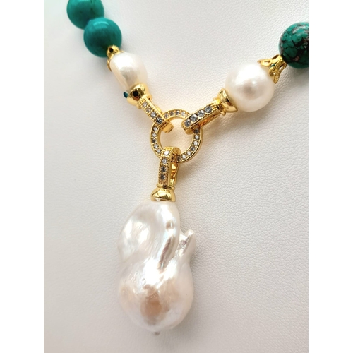 291 - An Exquisite Blue Turquoise and Baroque Pearl Necklace. 10mm turquoise beads lead to a Baroque Drop!... 