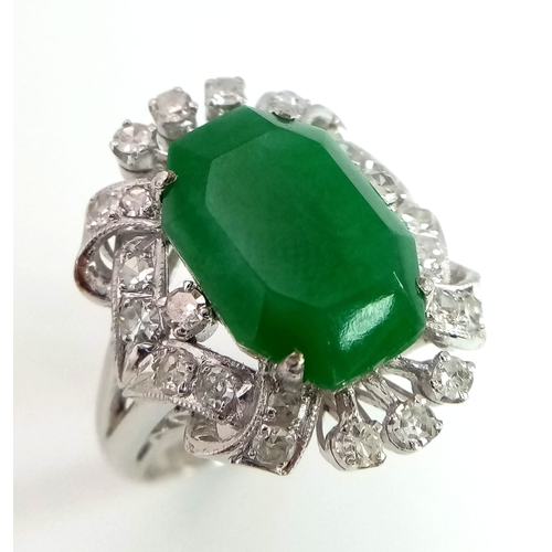 36 - An Art Deco Style 18K White Gold, Jade and Diamond Ring. Large octagonal cut jade with a healthy sur... 