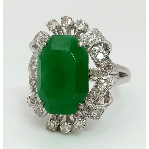 36 - An Art Deco Style 18K White Gold, Jade and Diamond Ring. Large octagonal cut jade with a healthy sur... 