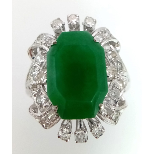 36 - An Art Deco Style 18K White Gold, Jade and Diamond Ring. Large octagonal cut jade with a healthy sur... 