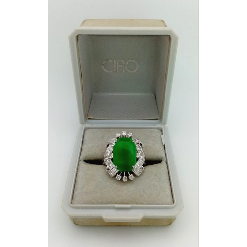 36 - An Art Deco Style 18K White Gold, Jade and Diamond Ring. Large octagonal cut jade with a healthy sur... 