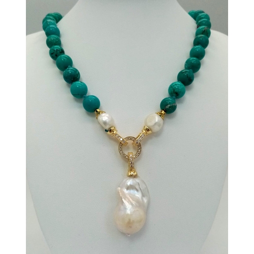 291 - An Exquisite Blue Turquoise and Baroque Pearl Necklace. 10mm turquoise beads lead to a Baroque Drop!... 